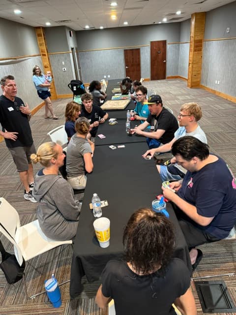 Participants playing cards at The Social Club